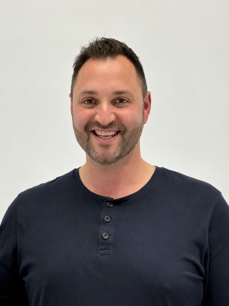 Public address announcer Rob Daniels smiling in a professional headshot