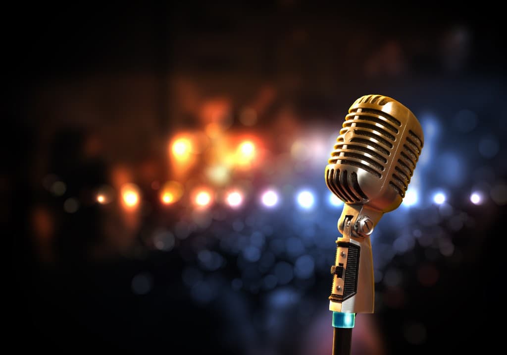 Classic broadcast microphone with stage lights, professional voice and event services