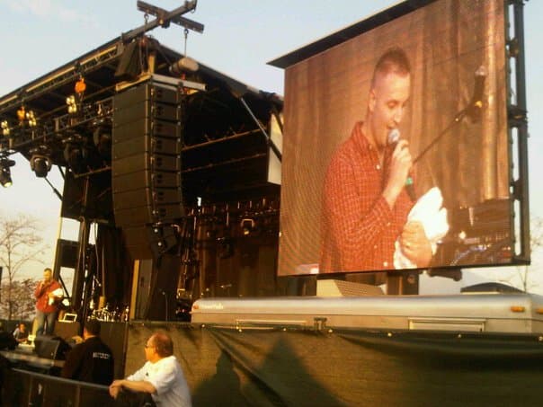 Event emcee Rob Daniels hosting a large outdoor concert from the main stage